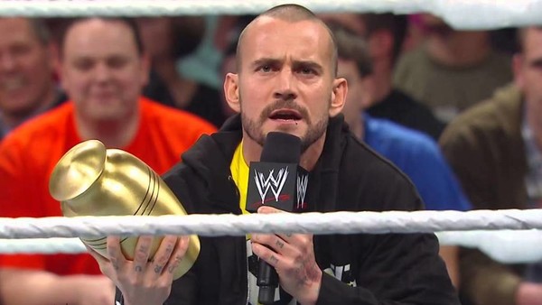 CM Punk holding the Undisputed WWE Championship after defeating Sami Zayn