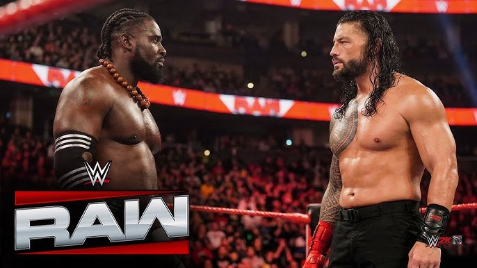Roman Reigns with the World Heavyweight Championship during his face-off with Seth Rollins on Monday Night Raw